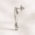 gold earring on a light beige background