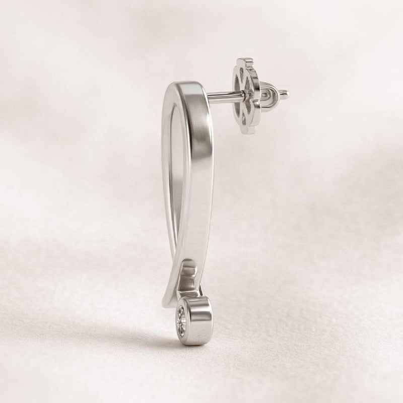 gold earring on a light beige background