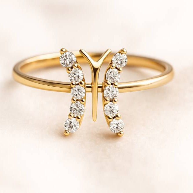 Gold ring with diamond accents on a light background