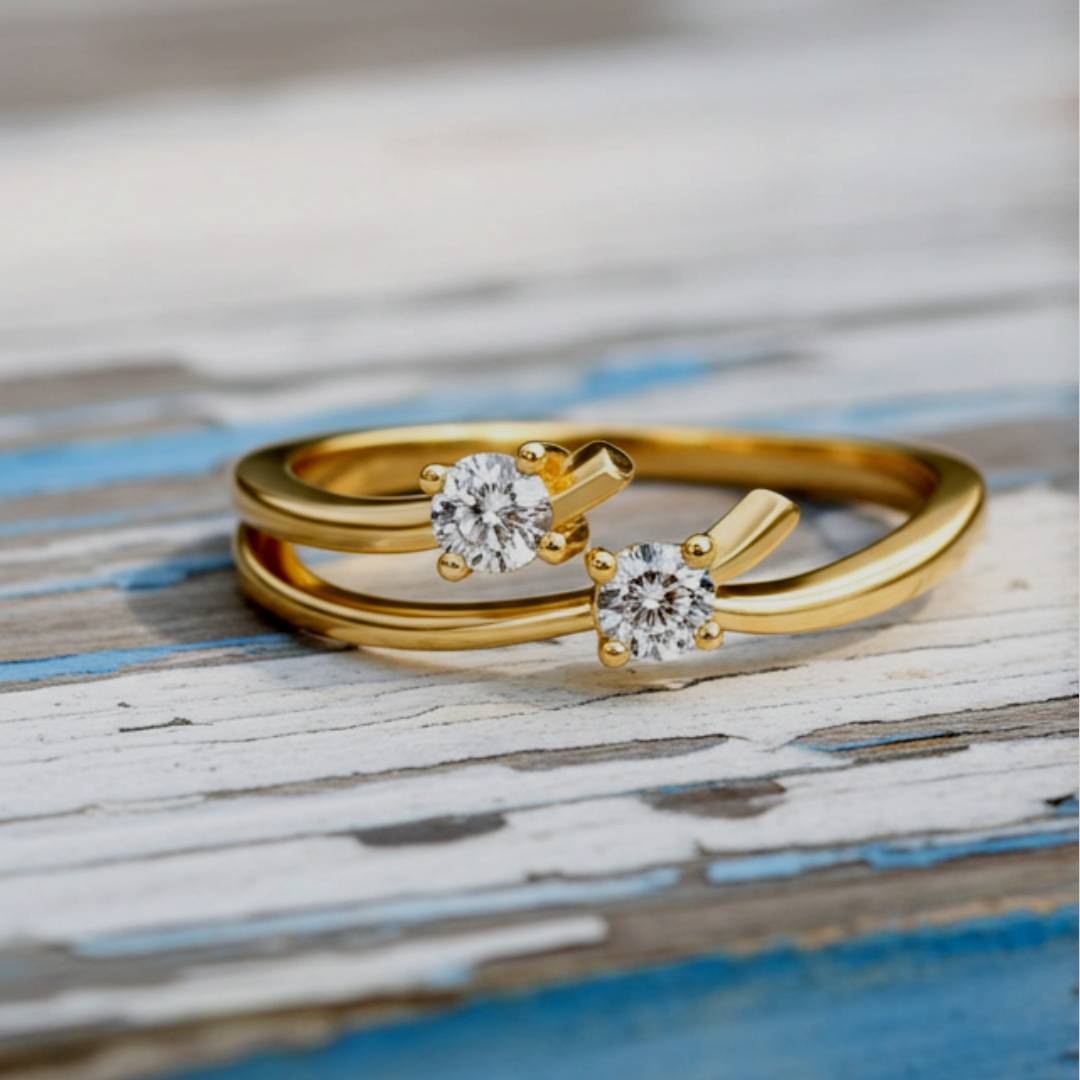 Gold ring with two diamonds on a wood background