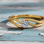 Gold ring with a diamond on a Wood background