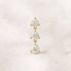 Gold and earring on a light beige background