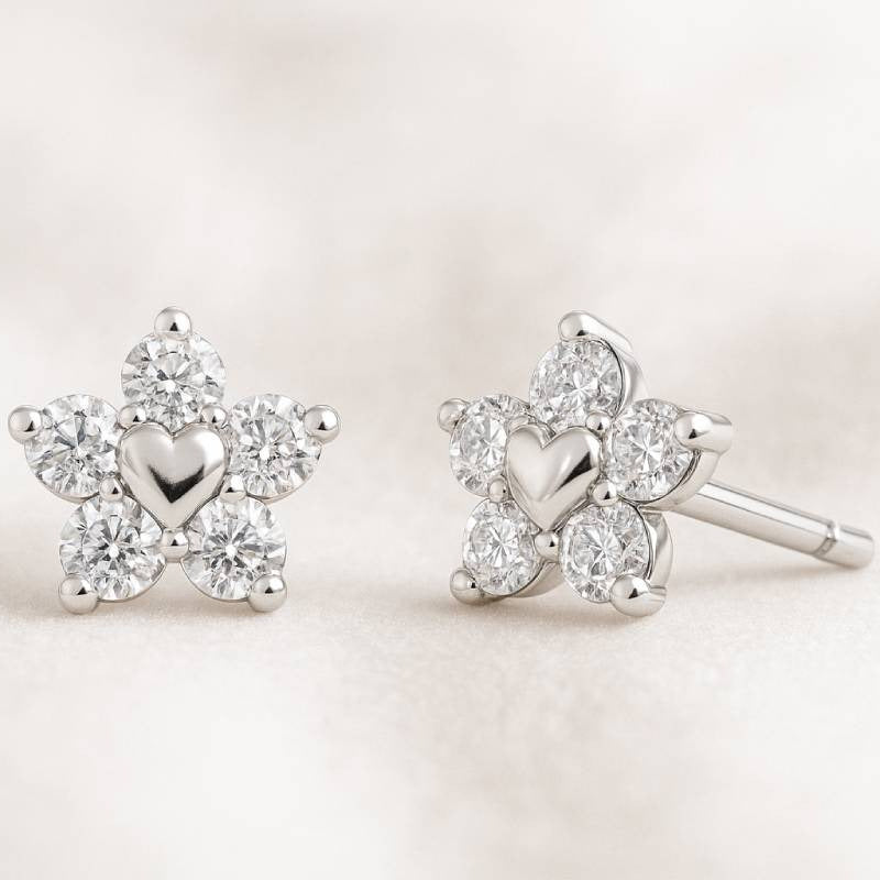 Star-shaped earrings with heart details on a light background