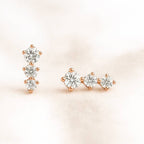 Pair of diamond earrings on a light pink background