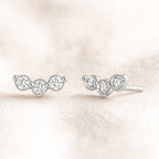 Pair of earrings with clear stones on a soft beige background