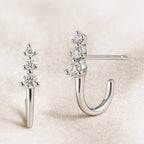 earrings with gemstones on a beige background