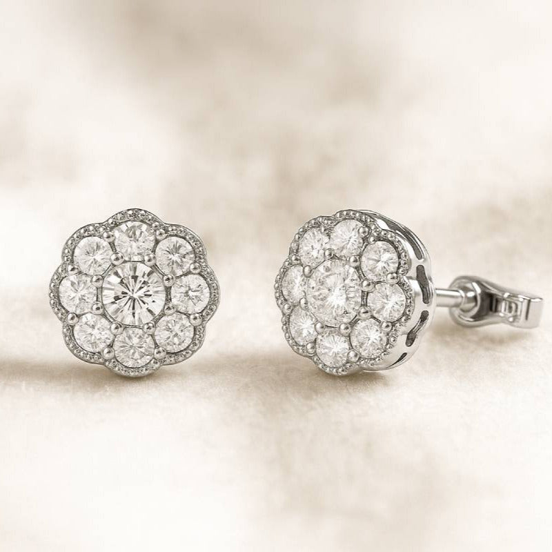 Pair of diamond earrings on a soft beige background