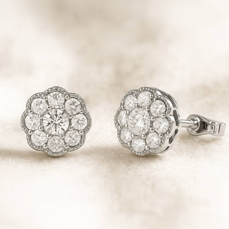 Pair of diamond earrings on a soft beige background