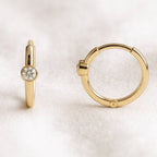 Gold hoop earrings on a white background