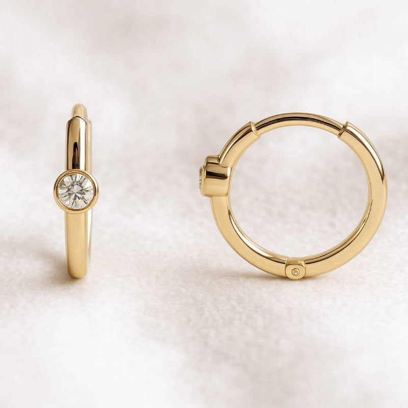 Gold hoop earrings on a white background