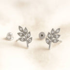 leaf-shaped earrings on a light beige background