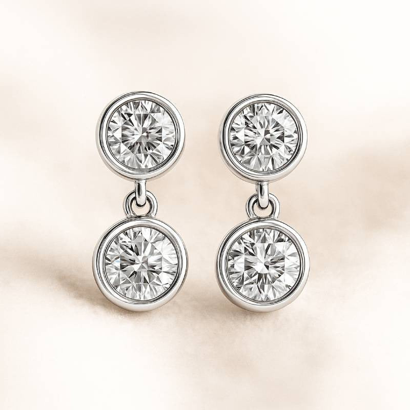 Pair of diamond earrings on a light background
