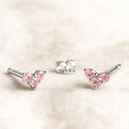 Pink sapphire earrings on a light pink background