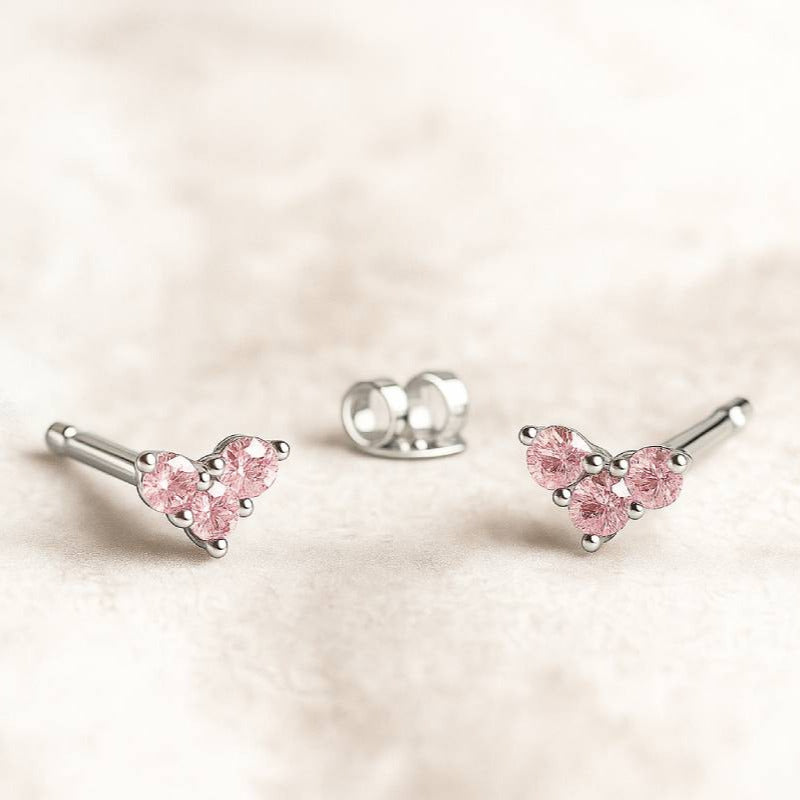 Pink sapphire earrings on a light pink background