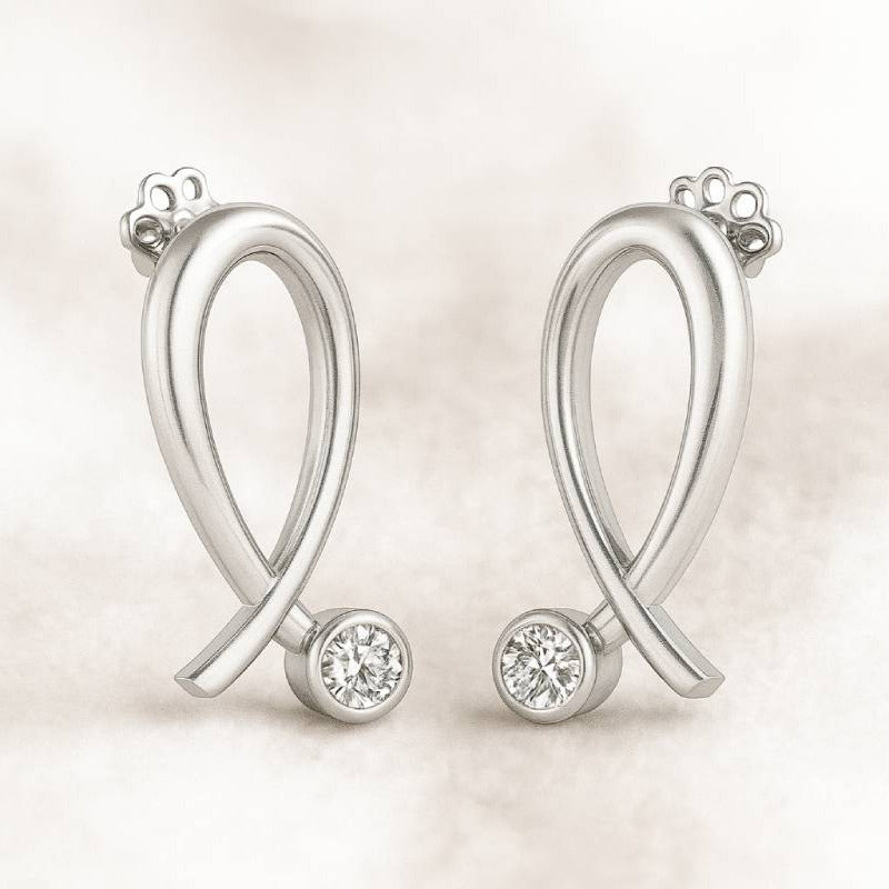  earrings with small round diamonds  on a light background