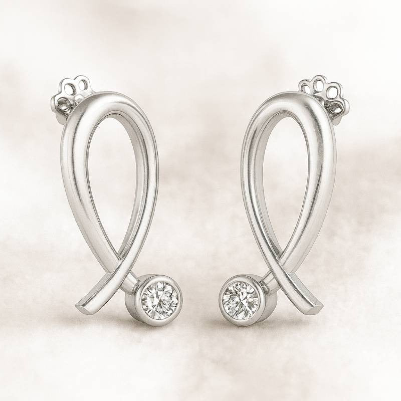 Gold earrings with diamonds on a light background