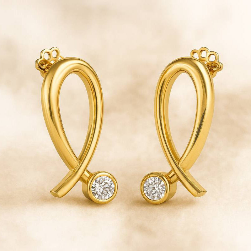 Gold earrings with diamond accents on a beige background