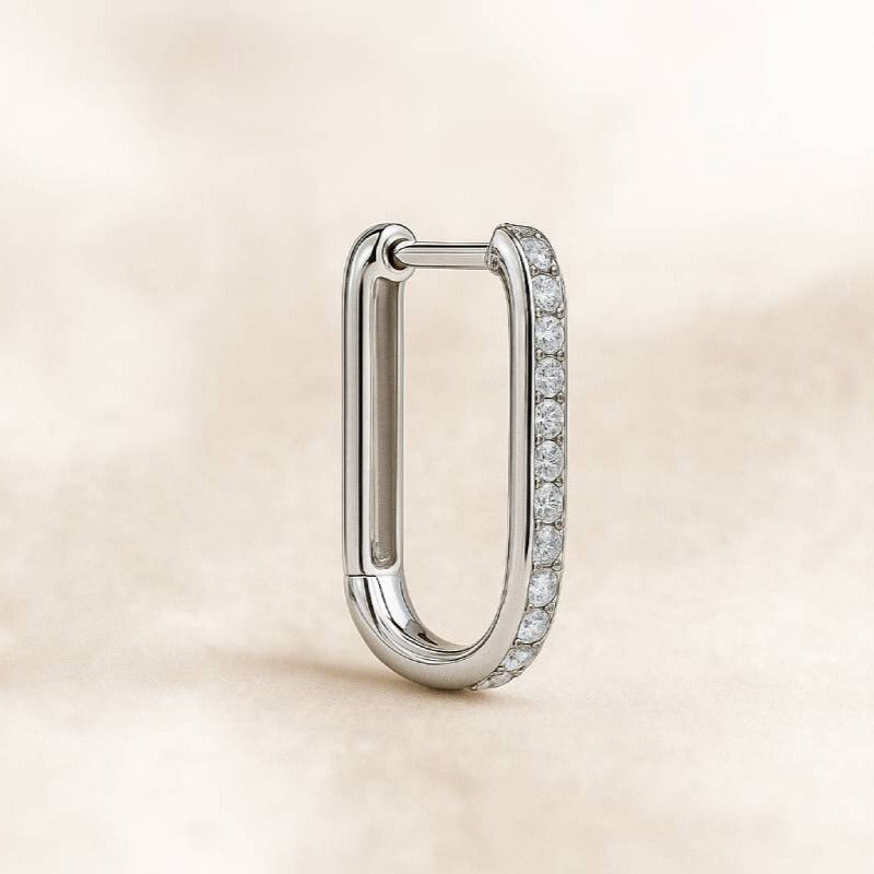  earring with small diamonds on a beige background