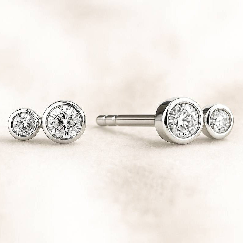 Pair of diamond stud earrings on a light background