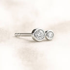 earring with clear gemstones on a light beige background