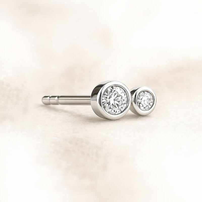 earring with clear gemstones on a light beige background