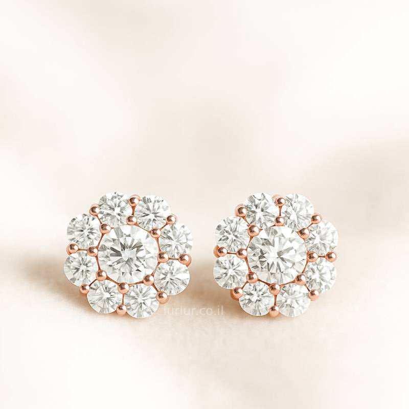 Pair of diamond earrings on a light pink background