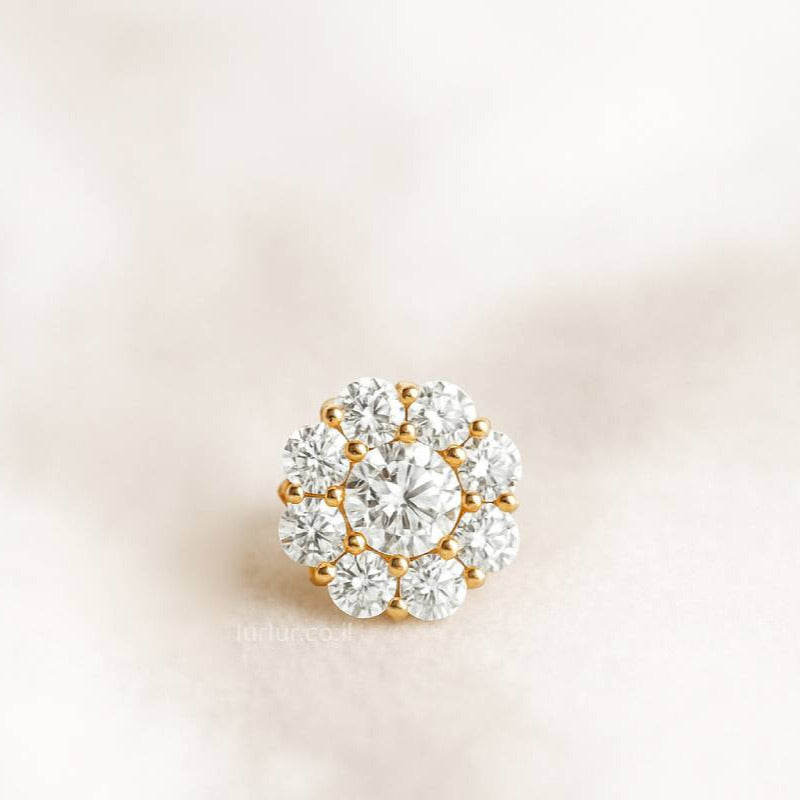 Diamond-studded brooch on a light pink background