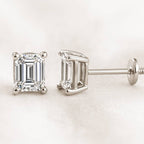 Diamond earrings on a light pink background