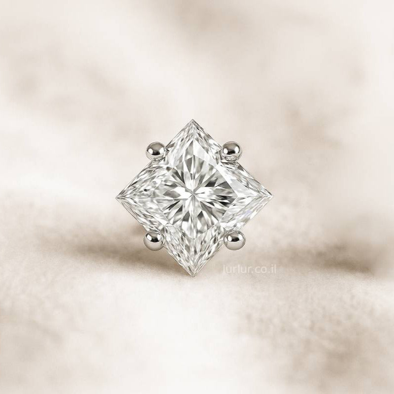 Diamond earring on a soft beige background
