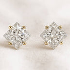 Pair of diamond stud earrings on a light background