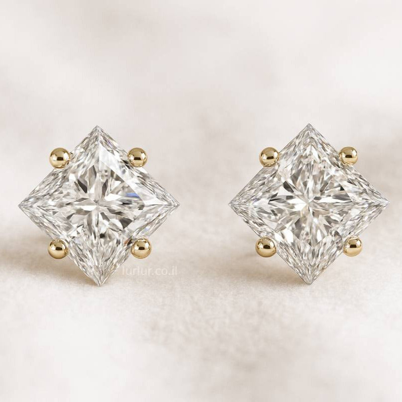 Pair of diamond stud earrings on a light background