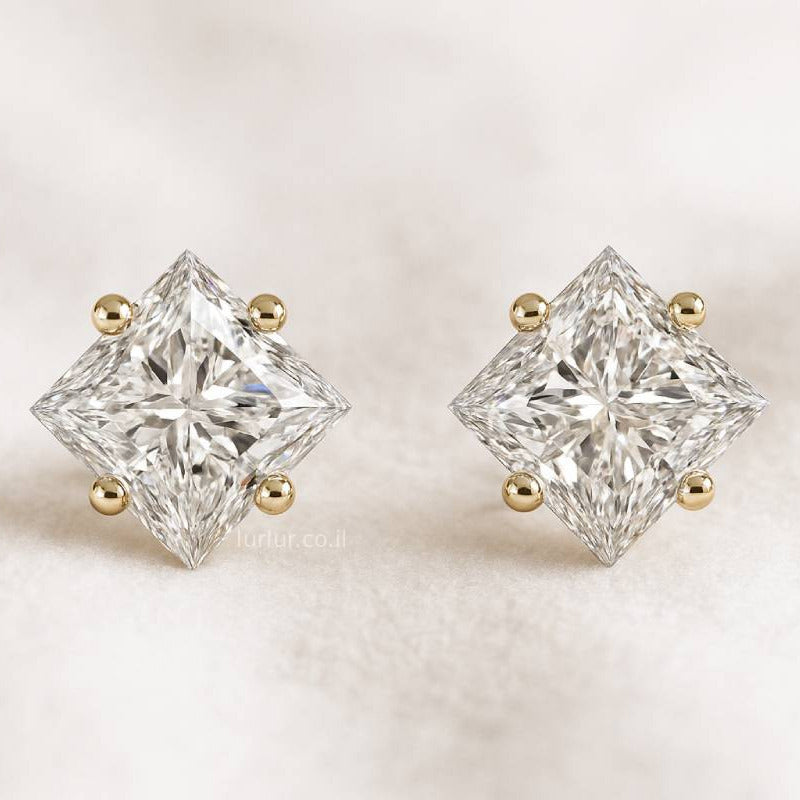Pair of diamond stud earrings on a light background