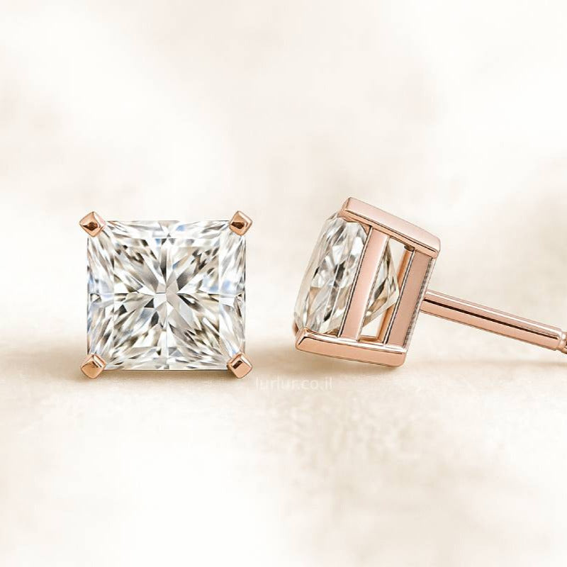 Rose gold diamond earrings on a light beige background