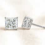 Pair of diamond earrings on a light background