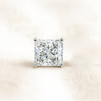 Square-cut diamond on a light beige background