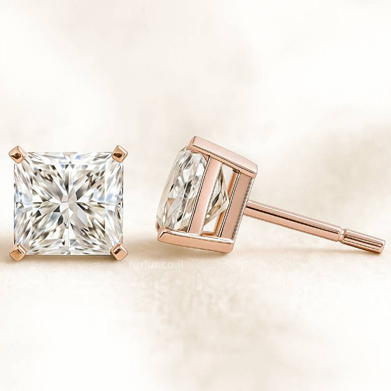 Rose gold diamond earrings on a light beige background