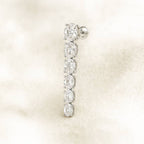 Diamond earring on a soft beige background