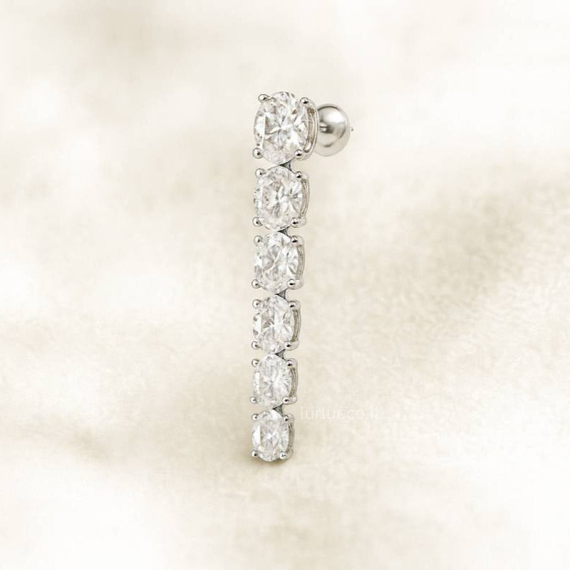 Diamond earring on a soft beige background