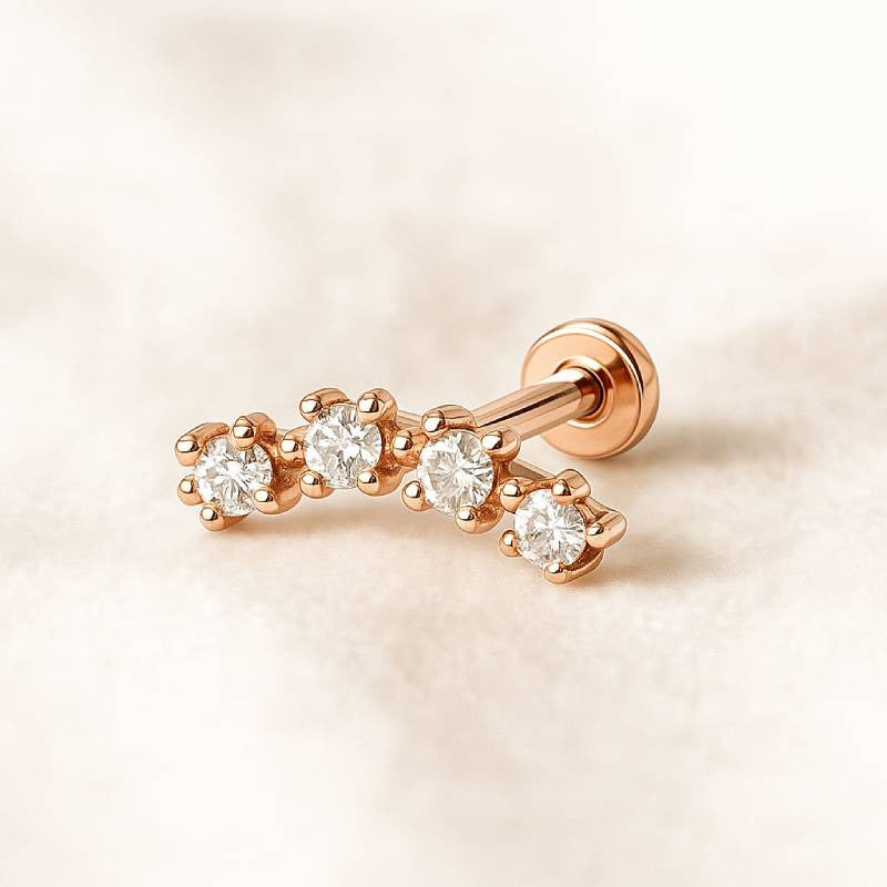 Rose gold earring with diamonds on a light pink background