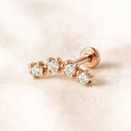Rose gold earring with diamonds on a light pink background