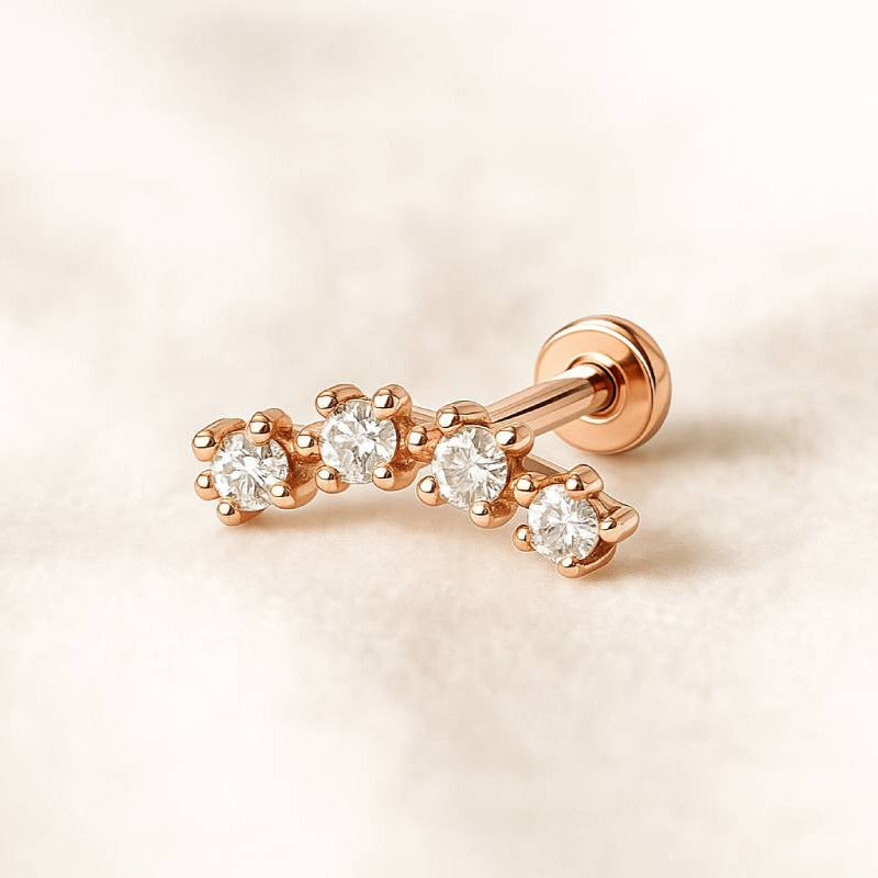 Rose gold earring with diamonds on a light pink background