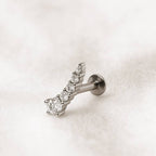 earring with clear diamonds on a light pink background