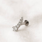  earring with clear gemstones on a light pink background