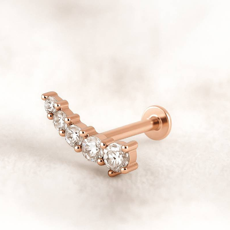 Rose gold and diamond earring on a light background