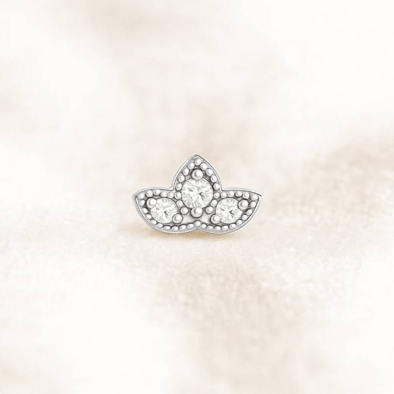 earring with clear gemstones on a light beige background