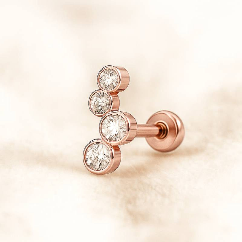 Rose gold earring with clear gemstones on a soft beige background