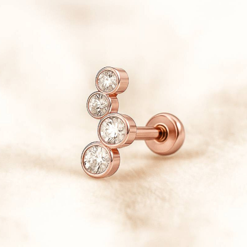 Rose gold earring with clear gemstones on a soft beige background