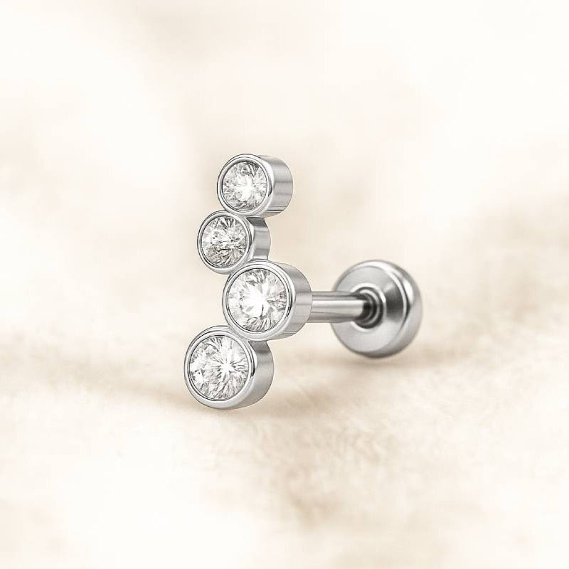  earring with three clear gemstones on a beige background