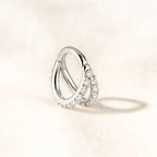 earrings with small diamonds on a light beige background