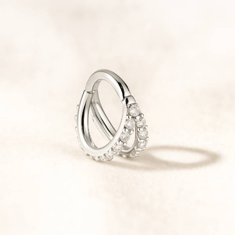 earrings with small diamonds on a light beige background